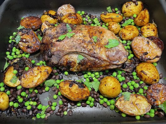 Slow cooked lamb shoulder with peas, mint, potatoes and black beans