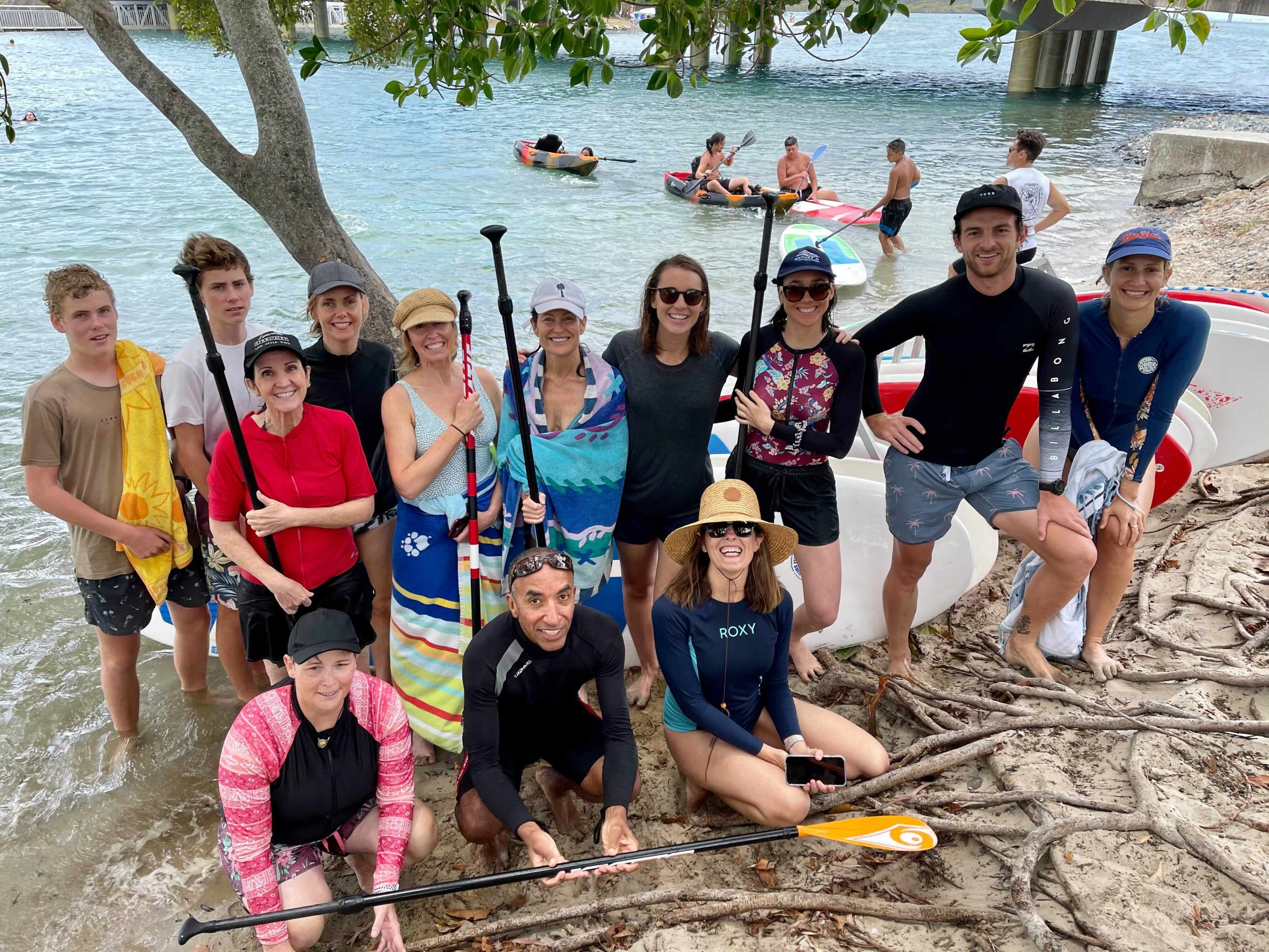 My Nutrition Clinic's dietitian team enjoying stand-up paddleboarding on the Gold Coast, demonstrating their commitment to active, healthy lifestyles