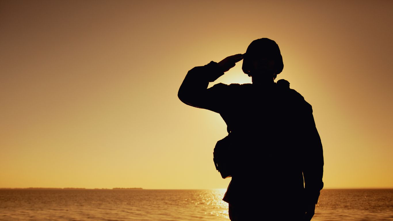 Dignified silhouette of an Australian veteran standing at attention in formal military pose