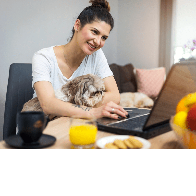 Woman having telehealth dietitian consultation on laptop while taking notes for weight management program